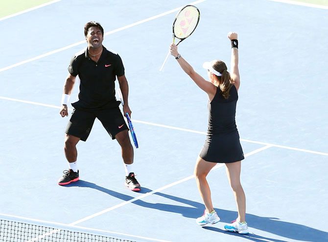 Leander Paes and Martina Hingis celebrate after defeating USA's Bethanie Mattek-Sands and Sam Querrey to win the 2015 US Open mixed-doubles title