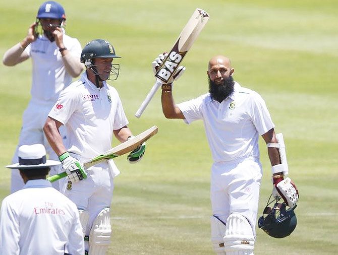 South Africa's Hashim Amla (right) celebrates scoring a century with AB de Villiers during the second cricket Test match against England in Cape Town on Monday