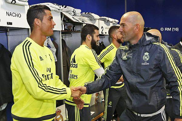 Real Madrid's new manager Zinedine Zidane greets club captain Cristiano Ronaldo before a practice session on Tuesday