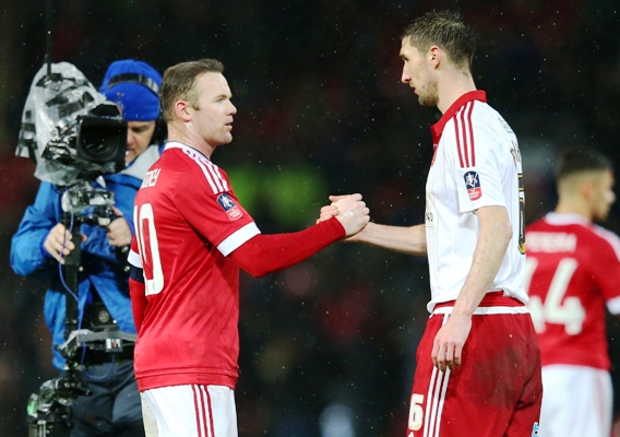 Wayne Rooney of Manchester United shakes hands with Chris Basham of Sheffield United 