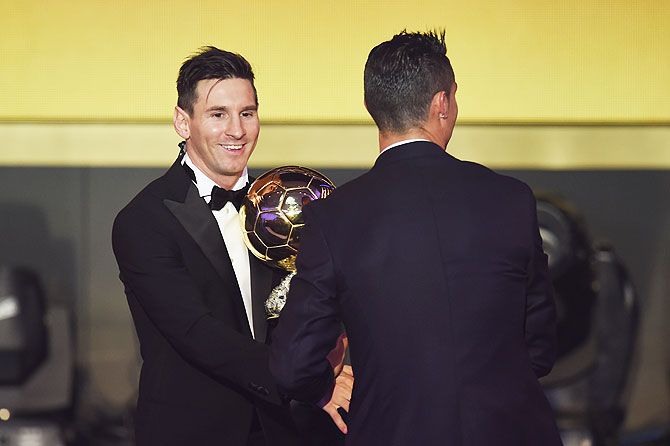 Lionel Messi is congratulated by Cristiano Ronaldo on winning the Ballon d'or