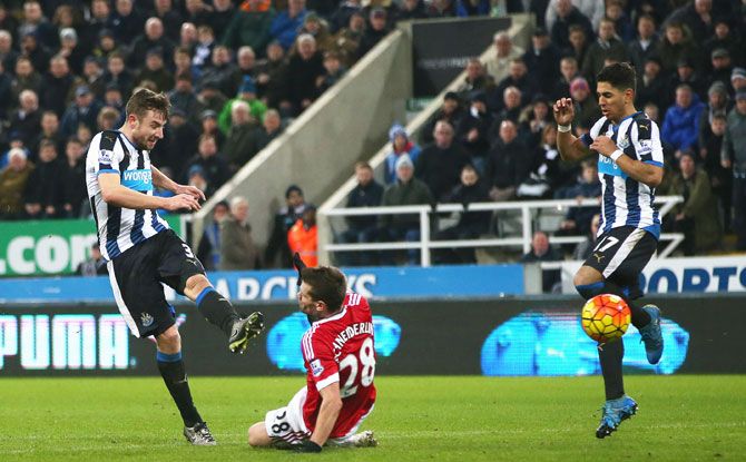 Newcastle United's Paul Dummett (left) scores the equaliser against Manchester United to help draw the match 3-3