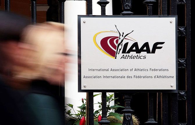 A woman walks past the IAAF (The International Association of Athletics Federations) headquarters in Monaco
