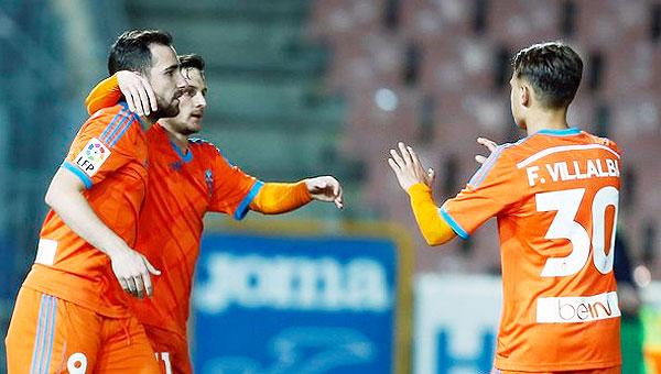 Valencia's Pablo Piatti celebrates with teammates after scoring against Granada on Thursday