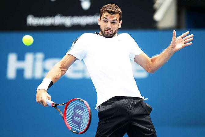 Bulgaria's Grigor Dimitrov plays a backhand against Alexandr Dolgopolov of Ukraine during their quarter-final on Friday