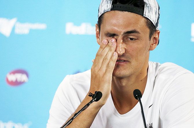 Australia's Bernard Tomic speaks at a news conference after withdrawing from his mens' singles quarter-final match against Russia's Teymuraz Gabashvili on Friday