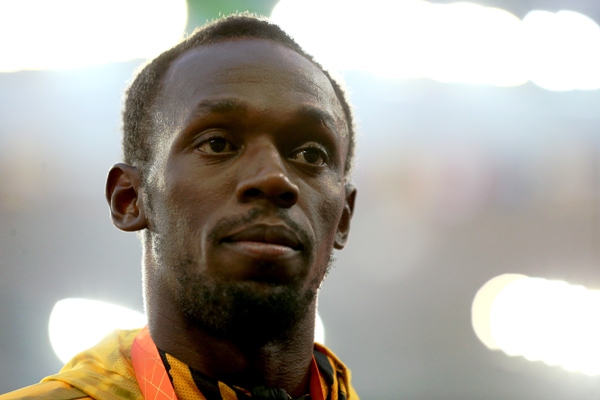Usain Bolt of Jamaica poses on the podium 