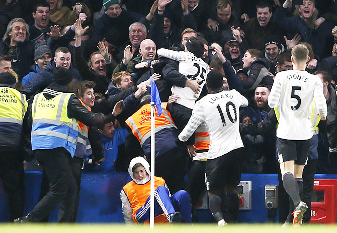 Everton's Ramiro Funes Mori celebrates with fans after scoring the third goal against Chelsea at Stamford Bridge