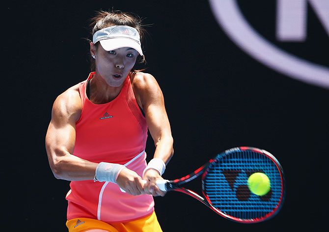 China's Qiang Wang plays a backhand in her first round match against USA's Sloane Stephens