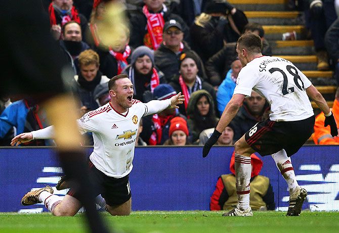 Manchester United's Wayne Rooney celebrates with Morgan Schneiderlin after scoring the winning goal against Liverpool at Anfield on Sunday