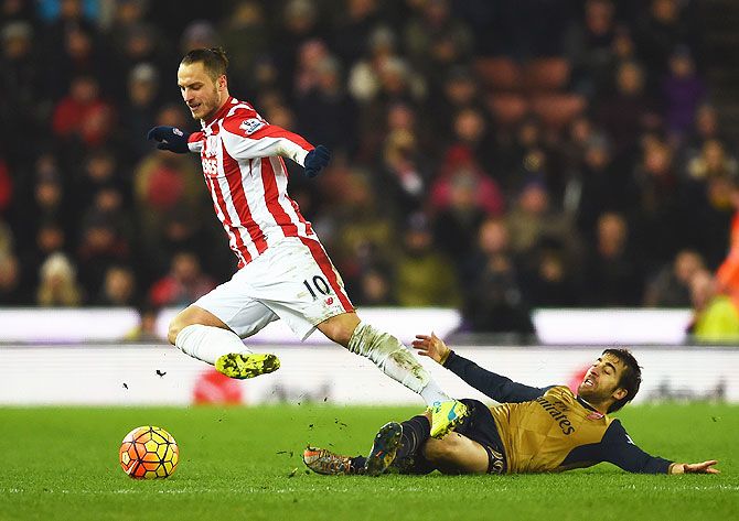 Stoke City's Marko Arnautovic is tackled by Arsenal's Mathieu Flamini during their Barclays English Premier League match at Britannia Stadium in Stoke on Trent on Sunday