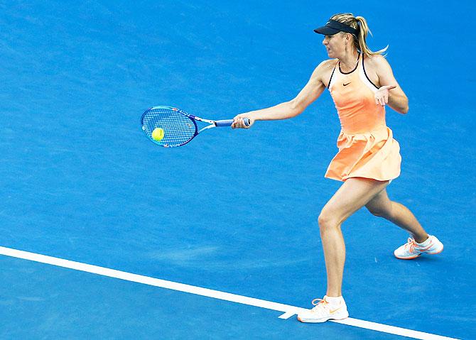 Russia's Maria Sharapova plays a forehand in her first round match against Japan's Nao Hibino