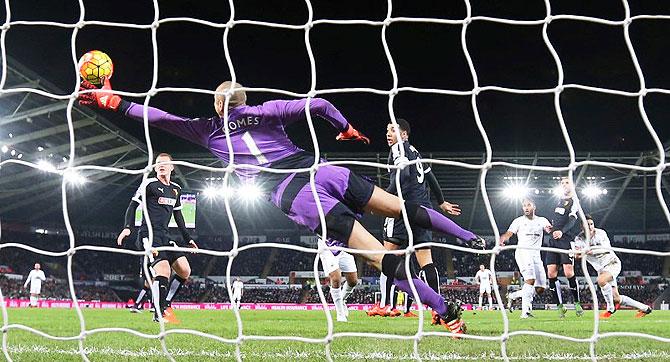 Swansea's Ashley Williams scores their first goal against Watford during their Barclays English Premier League match at Liberty Stadium in Swansea on Monday