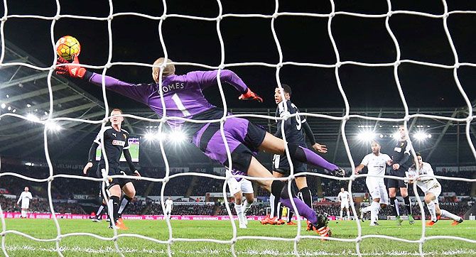 Swansea's Ashley Williams scores their first goal against Watford during their Barclays English Premier League match at Liberty Stadium in Swansea on Monday