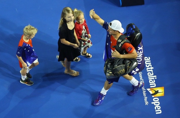 Lleyton Hewitt of Australia waves good bye to the crowd as he leaves the stadium with his kids 
