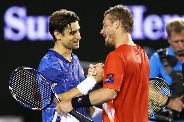 David Ferrer of Spain and Lleyton Hewitt of Australia meet at the net 