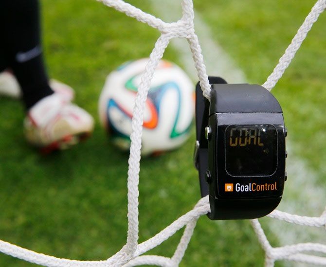 A GoalControl watch reads "goal" as a football rolls fully behind the goal line during a demonstration in the western German city of Aachen