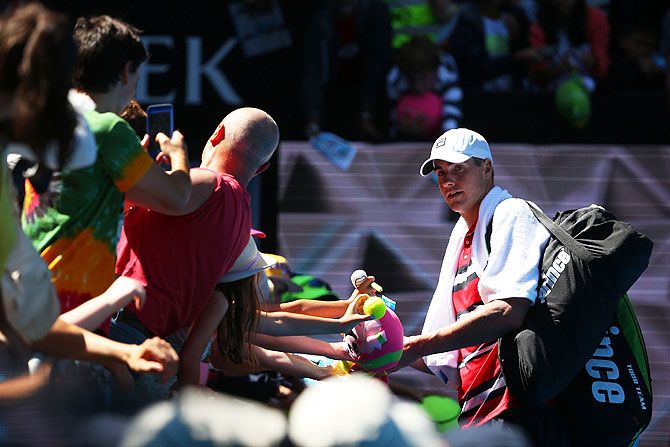 USA's John Isner celebrates with fans on winning his third round match against Spain's Feliciano Lopez