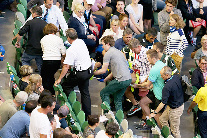 Nigel Sears, coach of Serbia's Ana Ivanovic, is carried away on a stretcher after he collapsed during Ivanovic's third round match against Madison Keys of the US, causing play to be suspended, at the Australian Open tennis tournament at Melbourne Park on Saturday