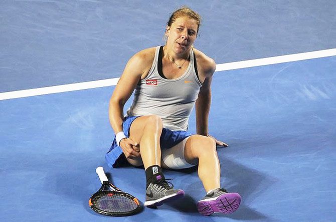 Anna-Lena Friedsam lies on the court as she suffers from an injury during her fourth round match against Agnieszka Radwanska