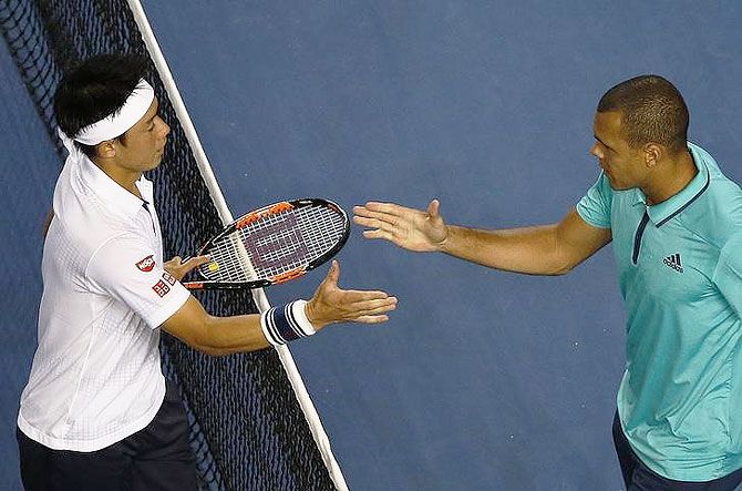 Japan's Kei Nishikori (left) shakes hands with France's Jo-Wilfried Tsonga after winning the fourth round match