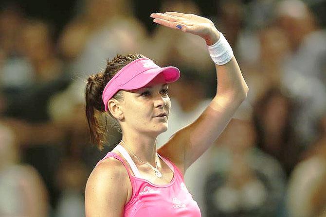 Poland's Agnieszka Radwanska waves after winning her fourth round match against Germany's Anna-Lena Friedsam