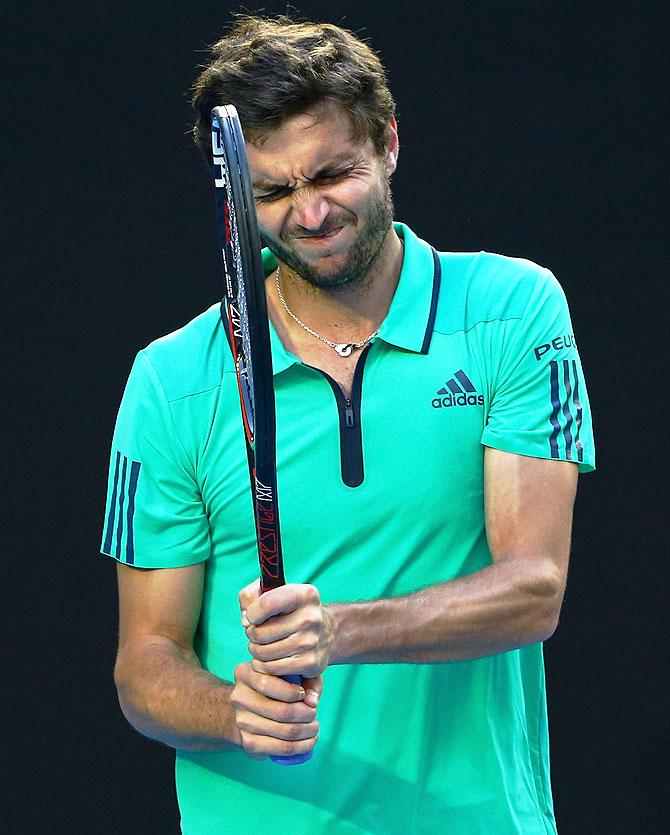 Gilles Simon reacts in his fourth round match against Novak Djokovic