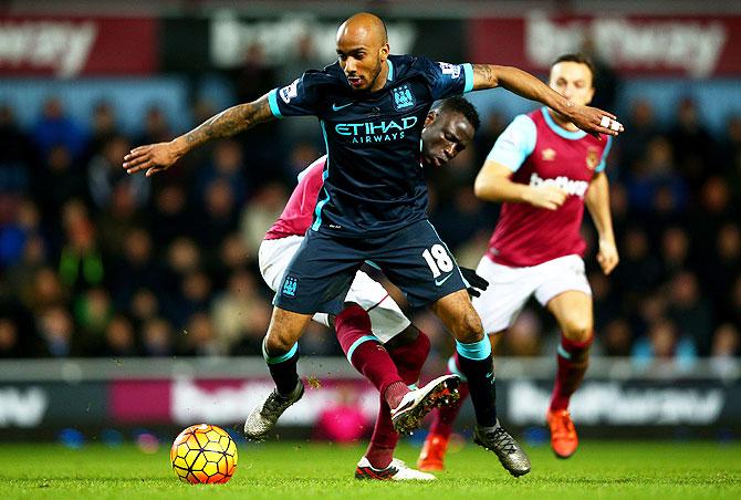 Manchester City's Fabian Delph evades West Ham United's Cheikhou Kouyate as they vie for possession during their Barclays English Premier League match at the Boleyn Ground in London on Saturday