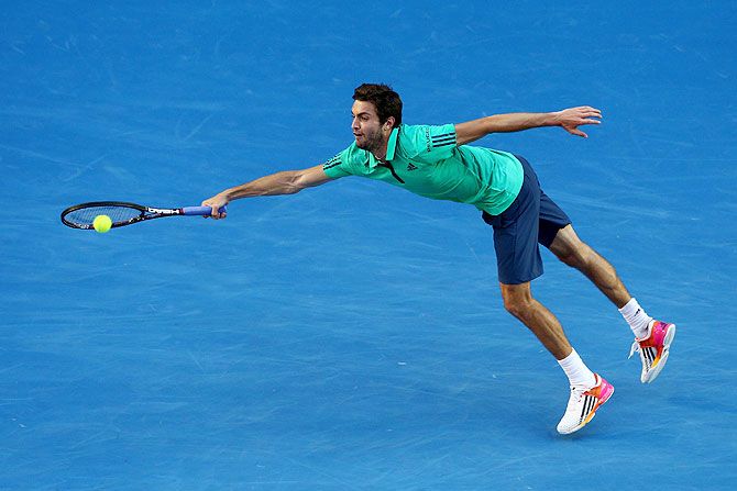 Gilles Simon stretches to play a forehand in his fourth round match against Novak Djokovic