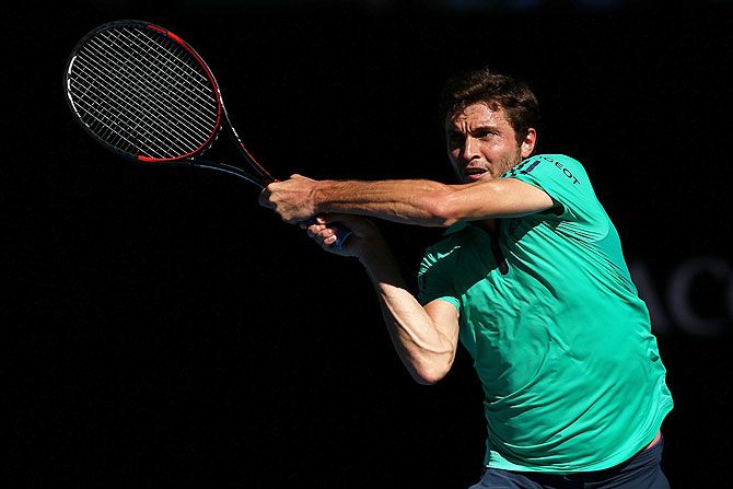 France's Gilles Simon plays a backhand in his fourth round match against Serbia's Novak Djokovic at the 2016 Australian Open at Melbourne Park on Sunday
