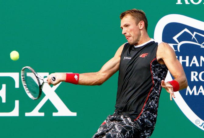 Poland's Lukasz Kubot returns a shot