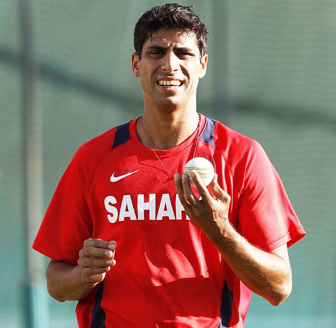 India's Ashish Nehra prepares to bowl in the nets during a practice session