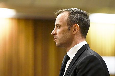 Oscar Pistorius stands in the dock at the North Gauteng High Court in Pretoria for a bail hearing on December 8, 2015
