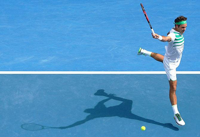 Switzerland's Roger Federer plays a backhand in his quarter-final match against Czech Republic's Tomas Berdych