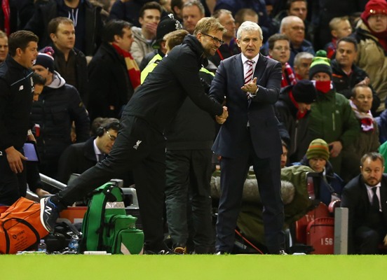 Jurgen Klopp manager of Liverpool and Mark Hughes manager of Stoke City shake hands 