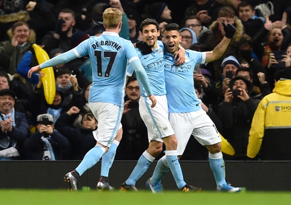 Sergio Aguero of Manchester City is congratulated by teammates David Silva and Kevin De Bruyne 