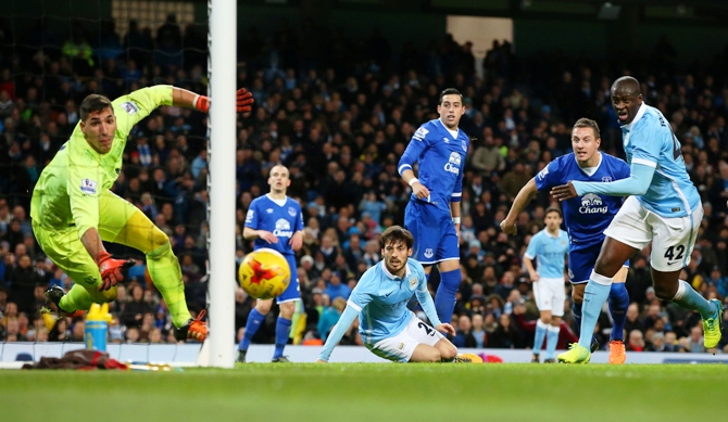David Silva of Manchester City looks on as his header hits the post 