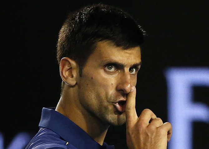 Novak Djokovic asks for silence during his semi-final match against Roger Federer at the Australian Open. Photograph: Tyrone Siu/Reuters