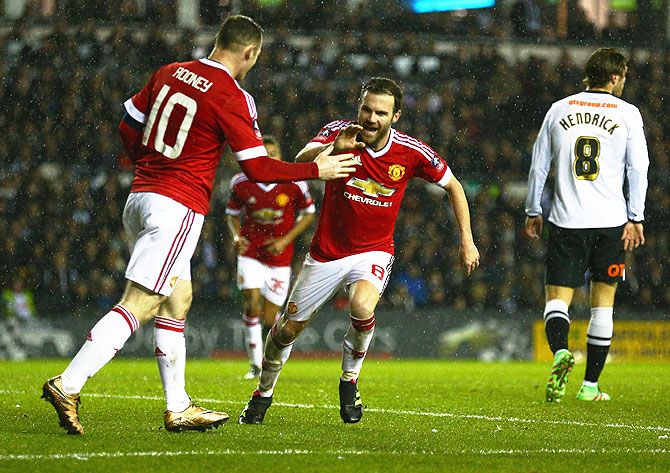 Manchester United's celebrates with Wayne Rooney (10) as he scores their third goal against Derby United in the Emirates FA Cup fourth round match at iPro Stadium in Derby on Friday