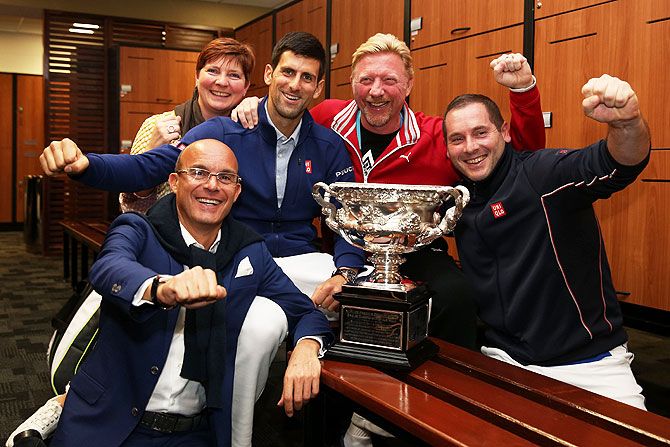Novak Djokovic with coach Boris Becker and his team celebrate in the locker room