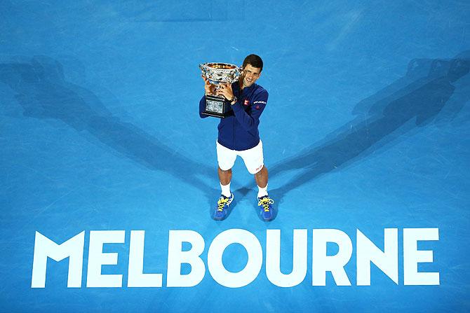 Novak Djokovic holds the Norman Brookes Challenge Cup