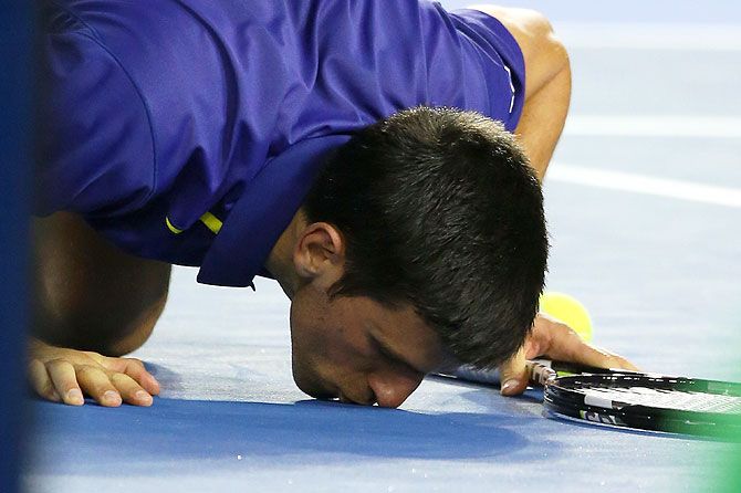 Novak Djokovic kisses the ground at Rod Laver Arena after winning the final