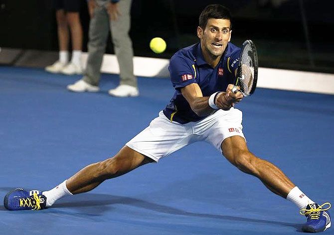 Novak Djokovic stretches to hit a forehand return