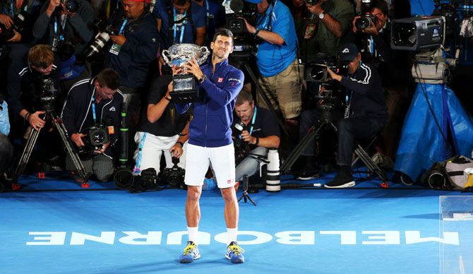 Serbia's Novak Djokovic holds the Norman Brookes Challenge Cup after defeating Great Britain's Andy Murray to win the 2016 Australian Open men's final at Melbourne Park on Sunday