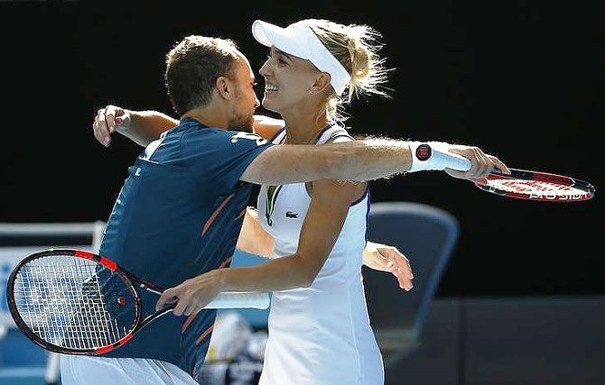 Russia's Elena Vesnina and Brazil's Bruno Soares celebrate after winning their mixed doubles final at the Australian Open tennis tournament on Sunday