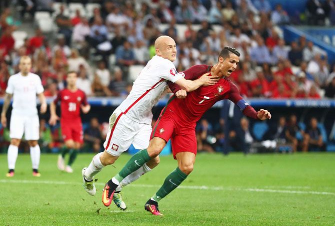 Portugal'S Cristiano Ronaldo is challenged by Poland'S Michal Pazdan in the penalty area during their Euro 2016 quarter final match between Poland and Portugal at Stade Velodrome on June 30, 2016 in Marseille, France