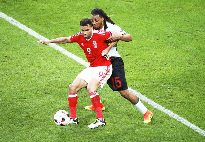 Belgium's Jason Denayer and Wales's Hal Robson-Kanu in action