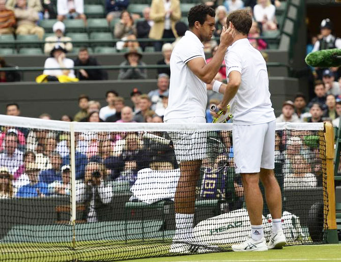 France's Richard Gasquet talks with France's Jo-Wilfried Tsonga as he retires from their match due to injury