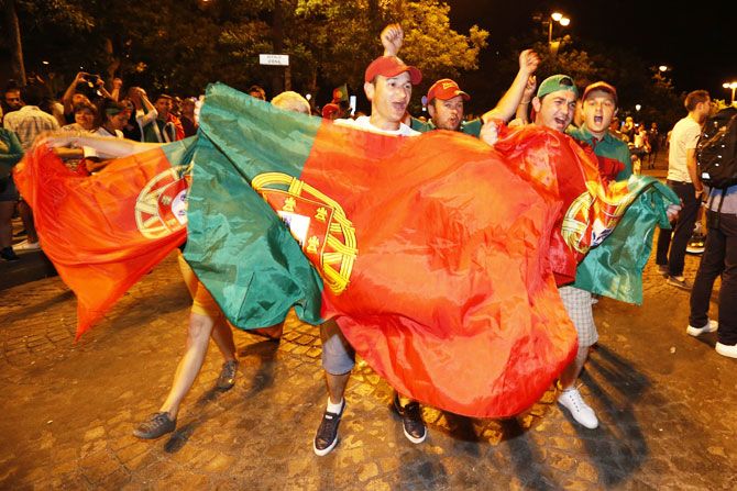 Portugal fans react on the Champs-Elysees after their team's win over France in the Euro 2016 final in Paris, on Sunday