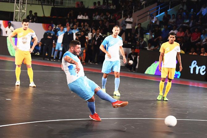 Mumbai 5's futsal player Adriano Foglia scores against Chennai 5's during their Premier Futsal match at Nehru Indoor Stadium in Chennai on Friday